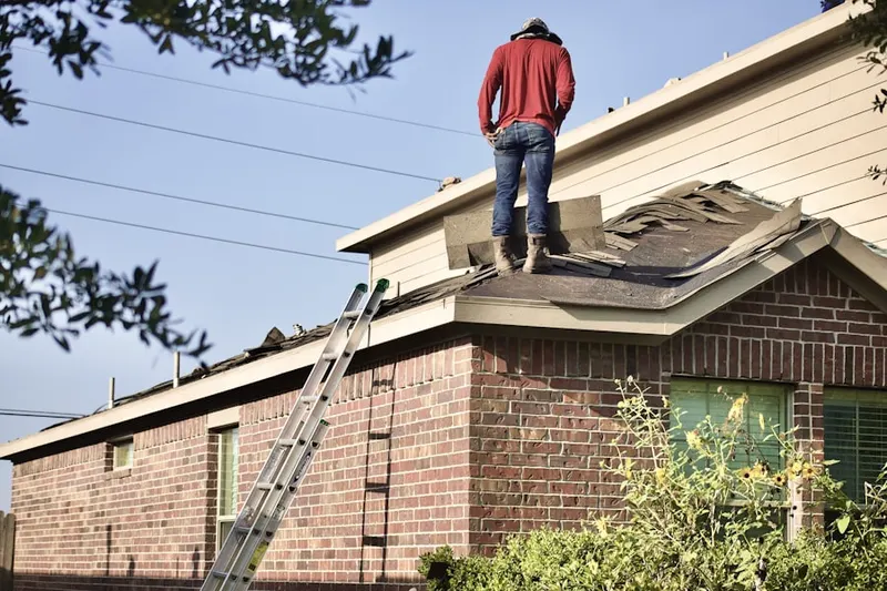 Professional roofer working on a residential roof in Pueblo